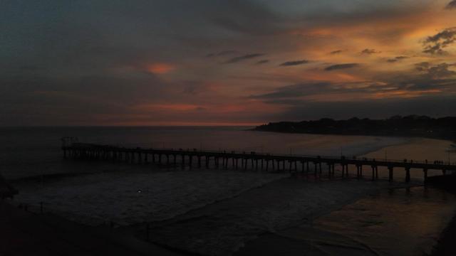 This view shows the sunset from the pier at the port of La Libertad, El Salvador, on October 9, 2026. (Photo by Marvin RECINOS / AFP)