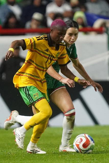 Jamaica’s midfielder #14 Deneisha Blackwood (L) controls the ball during the women's international friendly football match between Mexico and Jamaica at Victoria stadium in Aguascalientes, Mexico, on October 9, 2026. (Photo by Mario ARMAS / AFP)