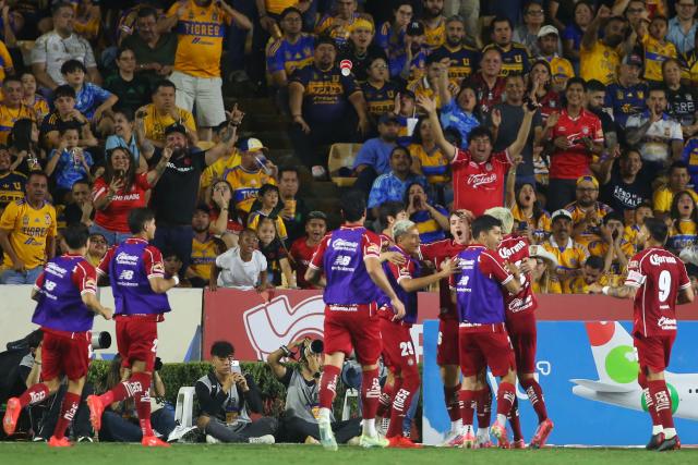 Toluca's Uruguayan forward #16 Federico Vinas (4nd R) celebrates scoring his team's second goal during the Liga MX Apertura tournament football match between Tigres and Toluca at Universitario de la UANL stadium in San Nicolas de los Garza, Nuevo Leon state, Mexico, on October 9, 2026. (Photo by Julio Cesar AGUILAR / AFP)