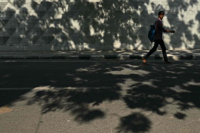 A man walks along a street in Chennai on October 10, 2026. (Photo by R.Satish BABU / AFP)