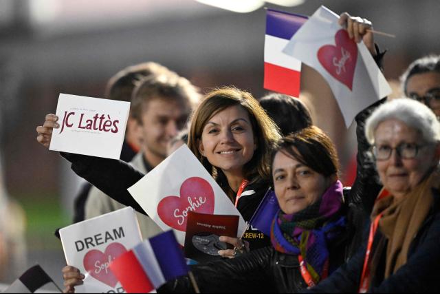 Friends and family of European Space Agency (ESA) French astronaut Sophie Adenot wait for her arrival at the Military Airport in Cologne, in the early hours of the morning on October 10, 2026, the day after she and three colleagues splashed down in the Pacific Ocean returning from their mission at the International Space Station (ISS). Sophie Adenot became the first French female astronaut to venture outside the International Space Station (ISS) for a spacewalk in late August 2026. (Photo by INA FASSBENDER / AFP)