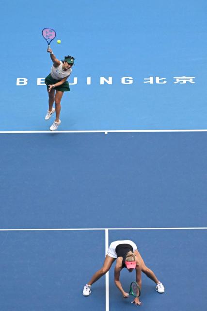 Indonesia's Aldila Sutjiadi (top) and New Zealand's Erin Routliffe play a point against Czech Republic's Katerina Siniakova and China's Zhang Shuai during their women's doubles semi-final match at the China Open tennis tournament in Beijing on October 10, 2026. (Photo by Adek BERRY / AFP)