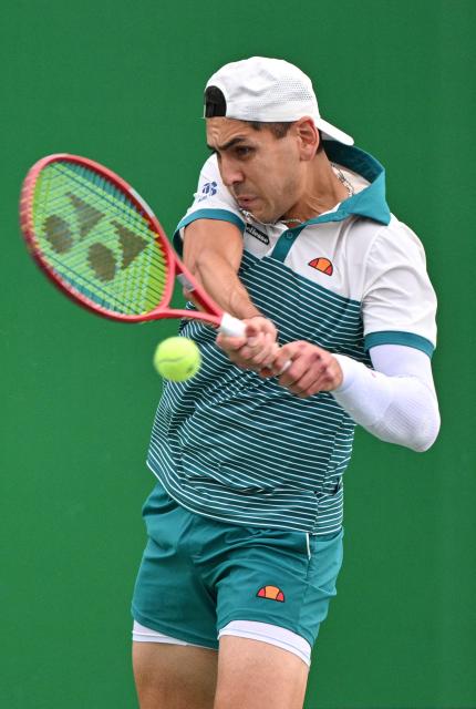 Chile's Alejandro Tabilo hits a return to Spain's Pablo Carreno Busta during their men's singles match at the Shanghai Masters tennis tournament in Shanghai on October 10, 2026. (Photo by Hector RETAMAL / AFP)