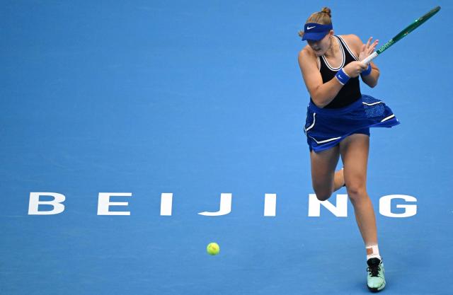 Russia’s Mirra Andreeva hits a return to Czech Republic's Nikola Bartunkova during their women’s singles semi-final at the China Open tennis tournament in Beijing on October 10, 2026. (Photo by Adek BERRY / AFP)