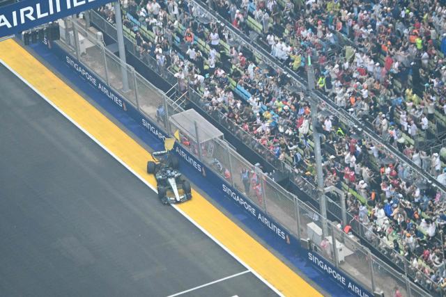 Mercedes' British driver George Russell suffers a crash during the sprint race ahead of the Formula One Singapore Grand Prix at the Marina Bay Street Circuit in Singapore on October 10, 2026. (Photo by ROSLAN RAHMAN / AFP)