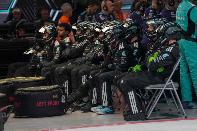 Mercedes' team members look on after British driver George Russell suffered a crash during the sprint race ahead of the Formula One Singapore Grand Prix at the Marina Bay Street Circuit in Singapore on October 10, 2026. (Photo by Ng Han Guan / POOL / AFP)