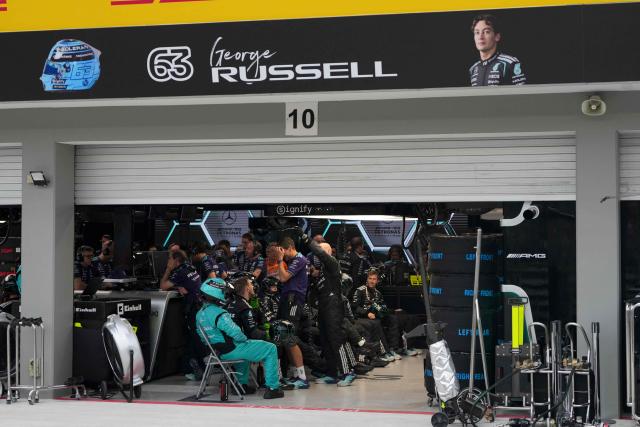 Mercedes' British driver George Russell's pit crew react after he suffered a crash during the sprint race ahead of the Formula One Singapore Grand Prix at the Marina Bay Street Circuit in Singapore on October 10, 2026. (Photo by Ng Han Guan / POOL / AFP)