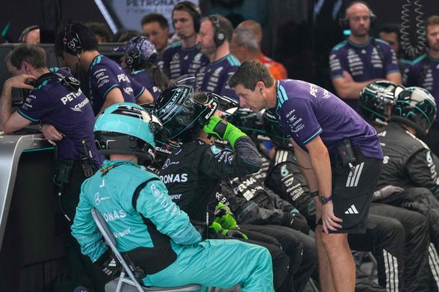 Mercedes' British driver George Russell's pit crew react after he suffered a crash during the sprint race ahead of the Formula One Singapore Grand Prix at the Marina Bay Street Circuit in Singapore on October 10, 2026. (Photo by Ng Han Guan / POOL / AFP)