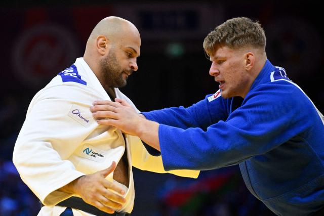Azerbaijan's Ushangi Kokauri (white) competes against Poland's Jakub Sordyl in the men's over 100 kg round of 16 at the World Judo Championships in Baku on October 10, 2026. (Photo by Alexander NEMENOV / AFP)