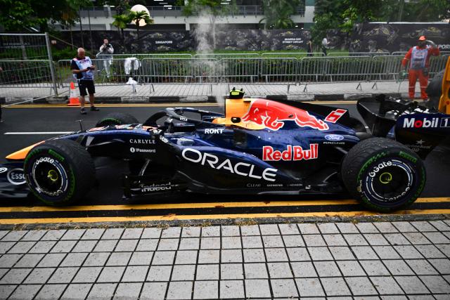 Red Bull Racing's French driver Isack Hadjar's car is extracted from track during the sprint race ahead of the Formula One Singapore Grand Prix at the Marina Bay Street Circuit in Singapore on October 10, 2026. (Photo by ANTHONY WALLACE / AFP)