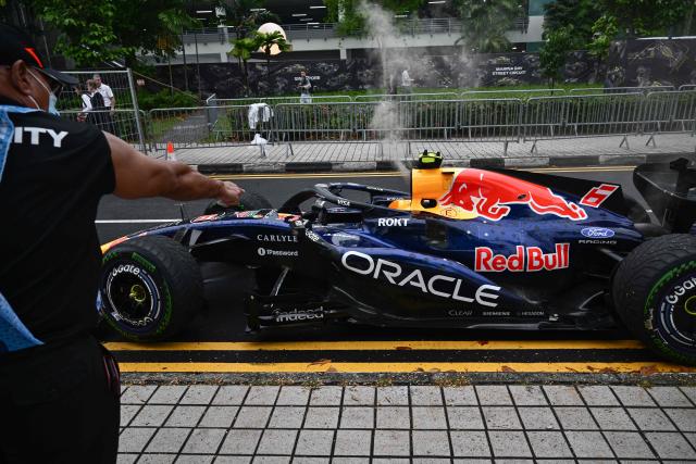 Red Bull Racing's French driver Isack Hadjar's car is extracted from track during the sprint race ahead of the Formula One Singapore Grand Prix at the Marina Bay Street Circuit in Singapore on October 10, 2026. (Photo by ANTHONY WALLACE / AFP)