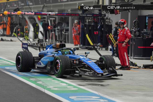 Williams' Thai driver Alexander Albon drives into the pit lane as he retires during the sprint race ahead of the Formula One Singapore Grand Prix at the Marina Bay Street Circuit in Singapore on October 10, 2026. (Photo by Ng Han Guan / POOL / AFP)