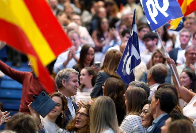 Spain's opposition Partido Popular (PP) party's leader Alberto Nunez Feijoo meets supporters as he arrives to a campaign rally in Madrid on October 10, 2026. Spain's Prime Minister called a snap election for November 29, after parliament rejected housing relief measures proposed by his minority government amid nationwide protests. The defeat was just the latest political setback for one of the few left-leaning government leaders still in power in Europe. (Photo by Oscar DEL POZO / AFP)