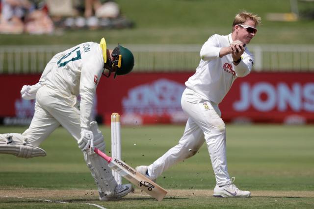 Australia's Nathan Lyon makes it safe to the crease as South Africa's Simon Harmer catches the ball on day two of the first Test match between South Africa and Australia at the Kingsmead stadium in Durban on October 10, 2026. (Photo by Marco Longari / AFP)