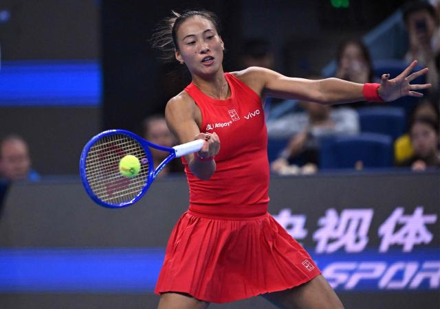 China’s Zheng Qinwen hits a return to Belgium’s Elise Mertens during their women’s singles semi-final at the China Open tennis tournament in Beijing on October 10, 2026. (Photo by ADEK BERRY / AFP)