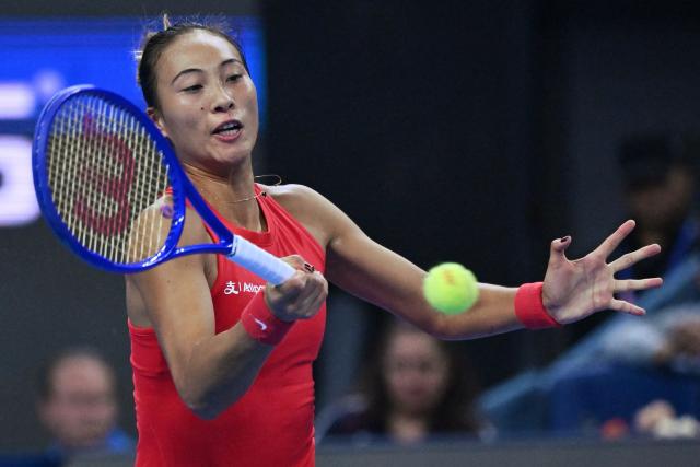 China’s Zheng Qinwen hits a return to Belgium’s Elise Mertens during their women’s singles semi-final at the China Open tennis tournament in Beijing on October 10, 2026. (Photo by ADEK BERRY / AFP)