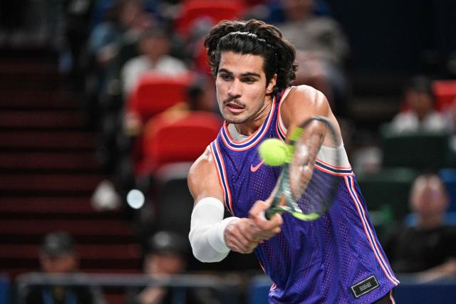 Spain's Carlos Alcaraz hits a return to Argentina's Juan Manuel Cerundolo during their men's singles match at the Shanghai Masters tennis tournament in Shanghai on October 10, 2026. (Photo by Hector RETAMAL / AFP)