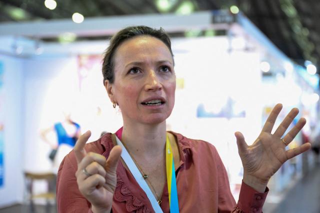 Charlotte Allibert, co-founder of Librinova, a self-publishing company and literary agency, speaks during an interview with AFP at the Frankfurt Book Fair in Frankfurt am Main, western Germany, on October 8, 2026. From October 7 to 11, 2026, publishing experts will meet up with partners from the technology and creative industries such as film and games at one of the world’s leading venues for printed and digital content with the Czech republic as guest of honour. (Photo by Kirill KUDRYAVTSEV / AFP)