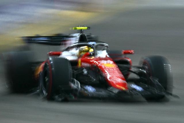 Ferrari's British driver Lewis Hamilton drives during the qualifying session ahead of the Formula One Singapore Grand Prix at the Marina Bay Street Circuit in Singapore on October 10, 2026. (Photo by ANTHONY WALLACE / AFP)