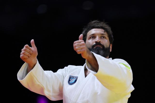 Russia's Inal Tasoev reacts after winning the men's over 100 kg gold medal bout at the World Judo Championships in Baku on October 10, 2026. (Photo by Anne-Christine POUJOULAT / AFP)