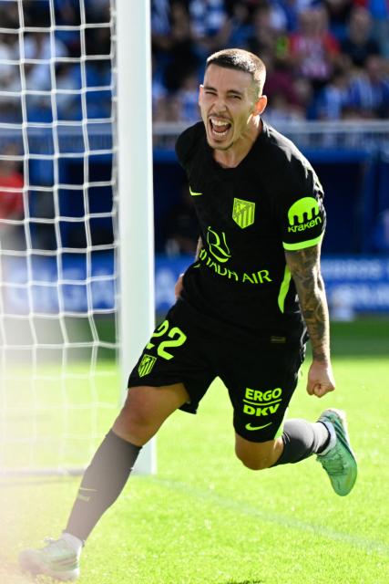 Atletico Madrid's Spanish defender #22 Alejandro Grimaldo celebrates scoring his team's first goal during the Spanish league football match between Deportivo Alaves and Club Atletico de Madrid at Mendizorroza Stadium in Vitoria on October 10, 2026. (Photo by ANDER GILLENEA / AFP)