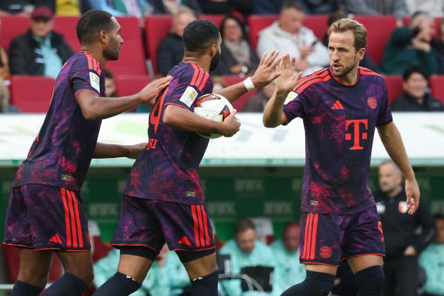 Bayern Munich's Moroccan midfielder #34 Ismael Saibari (C) celebrates scoring the 1-1 goal with his teammates Bayern Munich's English forward #09 Harry Kane (R) and  Bayern Munich's German defender #04 Jonathan Tah (L) during the German first division Bundesliga football match between FC Augsburg and FC Bayern Munich in Augsburg, southern Germany on October 10, 2026. (Photo by Karl-Josef HILDENBRAND / AFP) / DFL REGULATIONS PROHIBIT ANY USE OF PHOTOGRAPHS AS IMAGE SEQUENCES AND/OR QUASI-VIDEO