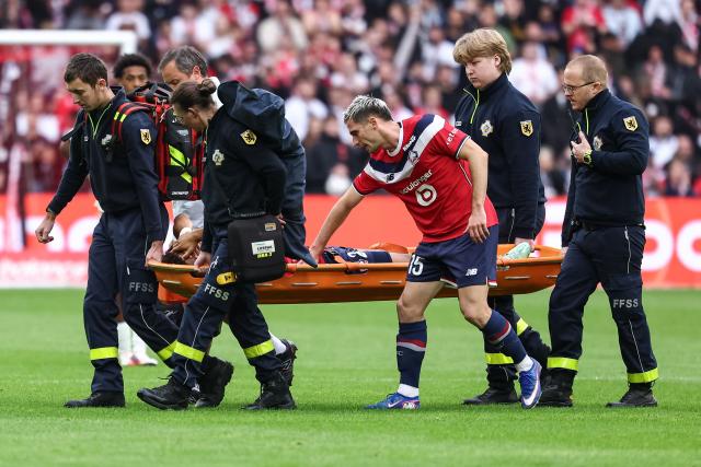 Lille's Portuguese defender #22 Tiago Santos is carried off the pitch after sustaining an injury during the French L1 football match between Lille LOSC and Le Havre AC at the Stade Pierre-Mauroy in Villeneuve-d'Ascq, northern France, on October 10, 2026. (Photo by Sameer Al-DOUMY / AFP)