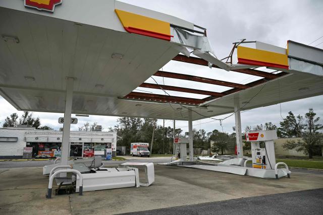 A view of a damaged gas station in Gulf Breeze, Florida, on October 10, 2026. The southeastern United States faced a high risk of flooding on Saturday as Isaias, weakened from a hurricane to a post-tropical cyclone, advanced northward from its landfall on Florida's Gulf Coast. Isaias roared ashore late Friday as a Category 2 hurricane near the resort community of Destin, Florida, packing sustained winds of 105 miles (165 kilometers) per hour, before weakening overnight, the National Hurricane Center (NHC) said. (Photo by RONALDO SCHEMIDT / AFP)