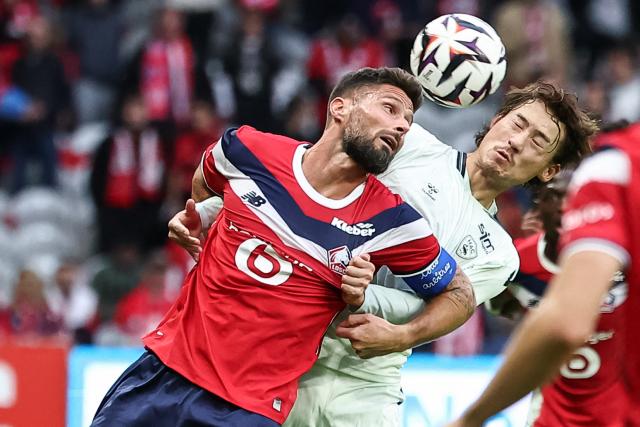 Le Havre's Japanese defender #15 Ayumu Seko (R) heads the ball next to Lille's French forward #09 Olivier Giroud (L) during the French L1 football match between Lille LOSC and Le Havre AC at the Stade Pierre-Mauroy in Villeneuve-d'Ascq, northern France, on October 10, 2026. (Photo by Sameer Al-DOUMY / AFP)