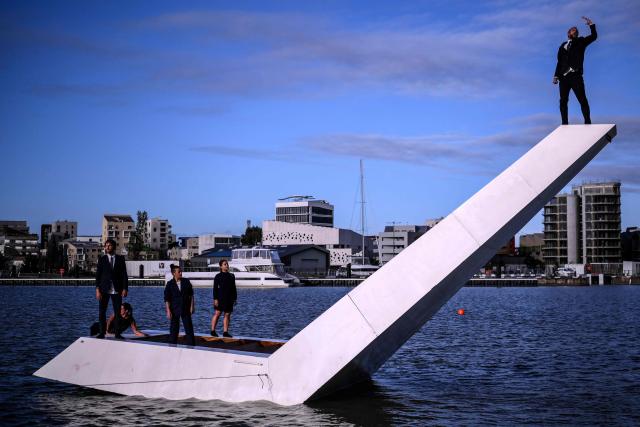 Members of the Dutch dance company Panama Pictures perform their show "The Weight of Water" over the tidal basin as part of the Festival International des Arts de Bordeaux (FAB) in Bordeaux, south-western France on October 10, 2026. (Photo by Christophe ARCHAMBAULT / AFP)