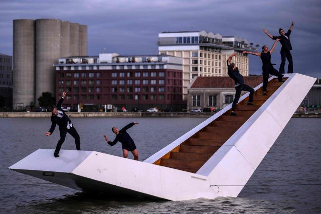 Members of the Dutch dance company Panama Pictures perform their show "The Weight of Water" over the tidal basin as part of the Festival International des Arts de Bordeaux (FAB) in Bordeaux, south-western France on October 10, 2026. (Photo by Christophe ARCHAMBAULT / AFP)