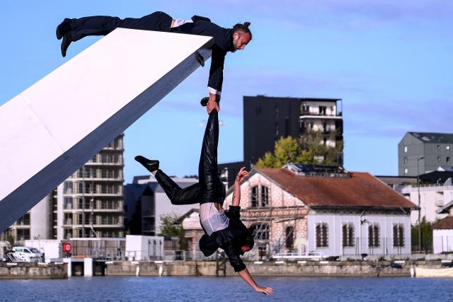 Members of the Dutch dance company Panama Pictures perform their show "The Weight of Water" over the tidal basin as part of the Festival International des Arts de Bordeaux (FAB) in Bordeaux, south-western France on October 10, 2026. (Photo by Christophe ARCHAMBAULT / AFP)