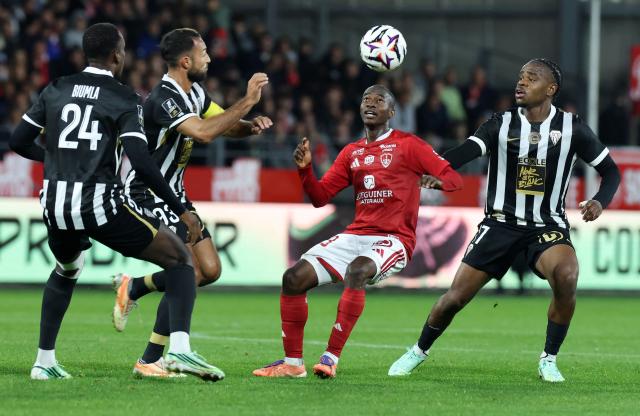 Brest's Malian midfielder #23 Kamory Doumbia (2nd R) fights for the ball with Angers's French defender #17 Joseph Kalulu (R) during the French L1 football match between Stade Brestois 29 (Brest) and SCO Angers at the Stade Francis-Le-Ble in Brest, western France, on October 10, 2026. (Photo by Fred TANNEAU / AFP)