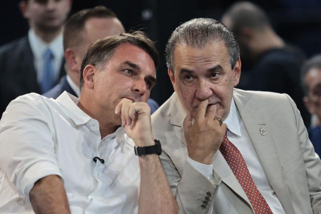 Brazilian senator and Liberal Party (PL) presidential candidate Flavio Bolsonaro (L) and evangelical pastor Silas Malafaia attend the official celebration marking the 100th anniversary of the Assembly of God (Madureira Ministry) at the Maracanazinho Gymnasium in Rio de Janeiro, Brazil, on October 10, 2026. (Photo by Douglas SHINEIDR / AFP)
