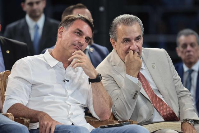 Brazilian senator and Liberal Party (PL) presidential candidate Flavio Bolsonaro (L) and evangelical pastor Silas Malafaia attend the official celebration marking the 100th anniversary of the Assembly of God (Madureira Ministry) at the Maracanazinho Gymnasium in Rio de Janeiro, Brazil, on October 10, 2026. (Photo by Douglas SHINEIDR / AFP)
