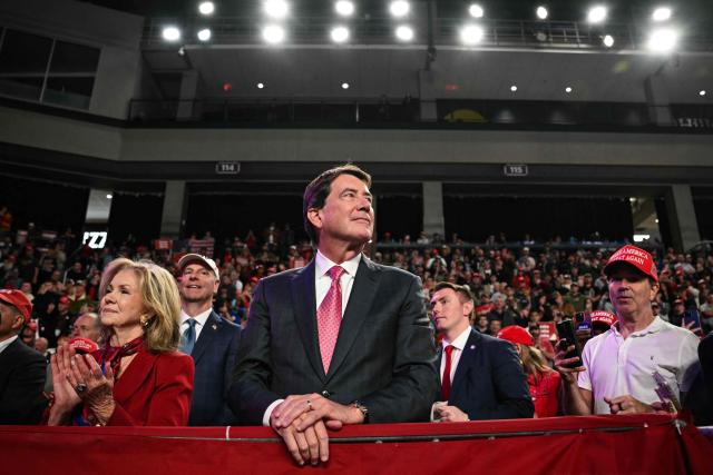 US Senator Marsha Blackburn (L) and US Senator Bill Bill Hagerty (C), both Republicans from Tennessee, look on as President Donald Trump speaks during a campaign rally at F&M Bank Arena in Clarksville, Tennessee on October 10, 2026. Trump is campaigning for Republican candidates ahead of the November 3 midterm election. (Photo by Mandel NGAN / AFP)