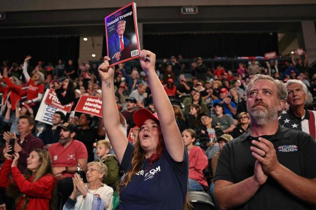 Audience members cheer as US President Donald Trump speaks during a campaign rally at F&M Bank Arena in Clarksville, Tennessee on October 10, 2026. Trump is campaigning for Republican candidates ahead of the November 3 midterm election. (Photo by Mandel NGAN / AFP)