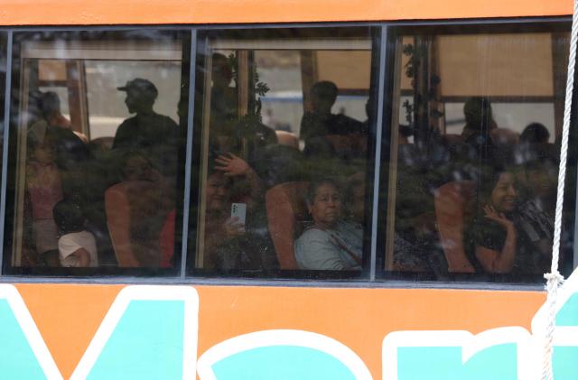 People look out from the windows of a ferry carrying evacuees from the community of Yelapa to the facilities of the 12th Naval Zone in Puerto Vallarta, Jalisco state, Mexico, on October 10, 2026, ahead of the potential impact of Hurricane Simon. Hurricane Simon strengthened into a powerful Category 4 storm as it moved toward Mexico's west coast, where it was expected to make landfall late on October 10 or early on October 11. (Photo by ULISES RUIZ / AFP)