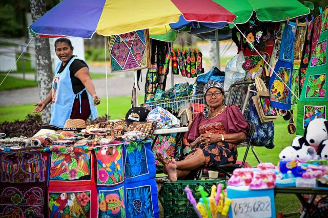 An Indigenous Guna woman sells handicrafts along the Cinta Costera in Panama City on October 10, 2026. (Photo by MARTIN BERNETTI / AFP)
