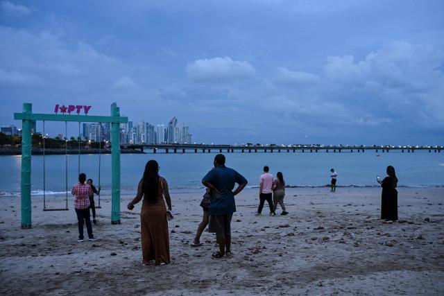 People enjoy the beach with the city in the background in Panama City's Casco Viejo on October 10, 2026. (Photo by MARTIN BERNETTI / AFP)