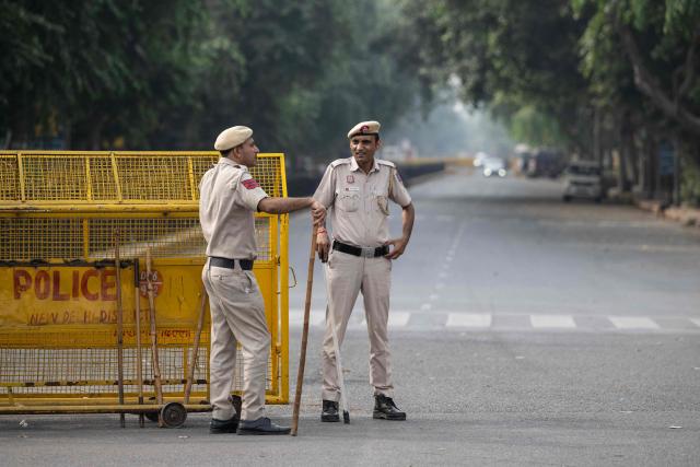 Police personnel stand guard at a temporary checkpoint amid ongoing protest demanding the resignation of India's Chief Election Commissioner Gyanesh Kumar over alleged voter roll irregularities linked to the "special intensive revision" (SIR), near Jantar Mantar in New Delhi on October 11, 2026. A New Delhi court ordered on October 11 the release of three leaders of the "cockroach" movement, including its founder Abhijeet Dipke, their lawyer said, a day after they were detained. (Photo by Sajjad HUSSAIN / AFP)