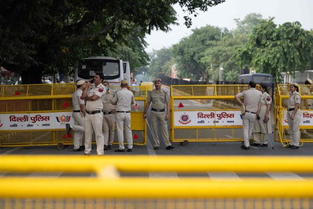 Police personnel stand guard at a temporary checkpoint amid ongoing protest demanding the resignation of India's Chief Election Commissioner Gyanesh Kumar over alleged voter roll irregularities linked to the "special intensive revision" (SIR), near Jantar Mantar in New Delhi on October 11, 2026. A New Delhi court ordered on October 11 the release of three leaders of the "cockroach" movement, including its founder Abhijeet Dipke, their lawyer said, a day after they were detained. (Photo by Sajjad HUSSAIN / AFP)