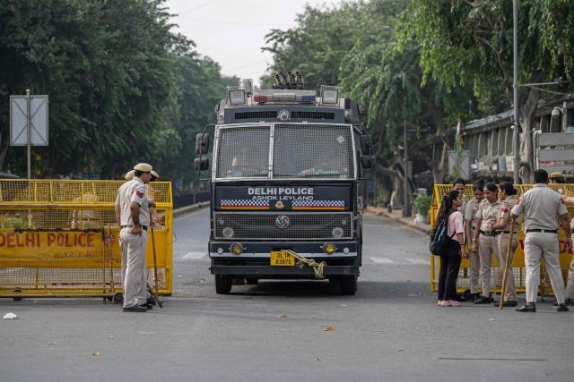 A multi-barrel teargas shell launching vehicle drives past a temporary checkpoint amid ongoing protests demanding the resignation of India's Chief Election Commissioner Gyanesh Kumar over alleged voter roll irregularities linked to the "special intensive revision" (SIR), near Jantar Mantar in New Delhi on October 11, 2026. A New Delhi court ordered on October 11 the release of three leaders of the "cockroach" movement, including its founder Abhijeet Dipke, their lawyer said, a day after they were detained. (Photo by Sajjad HUSSAIN / AFP)