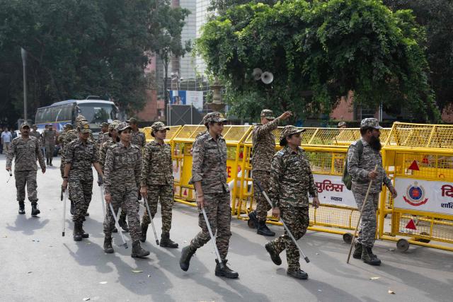 Security personnel arrive for their deployment at a temporary checkpoint amid ongoing protests demanding the resignation of India's Chief Election Commissioner Gyanesh Kumar over alleged voter roll irregularities linked to the "special intensive revision" (SIR), near Jantar Mantar in New Delhi on October 11, 2026. A New Delhi court ordered on October 11 the release of three leaders of the "cockroach" movement, including its founder Abhijeet Dipke, their lawyer said, a day after they were detained. (Photo by Sajjad HUSSAIN / AFP)