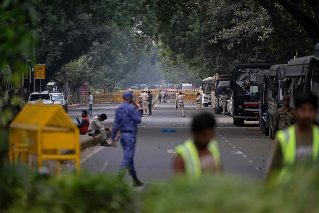 Security personnel are seen at a blocked road amid ongoing protests demanding the resignation of India's Chief Election Commissioner Gyanesh Kumar over alleged voter roll irregularities linked to the "special intensive revision" (SIR), near Jantar Mantar in New Delhi on October 11, 2026. A New Delhi court ordered on October 11 the release of three leaders of the "cockroach" movement, including its founder Abhijeet Dipke, their lawyer said, a day after they were detained. (Photo by Sajjad HUSSAIN / AFP)