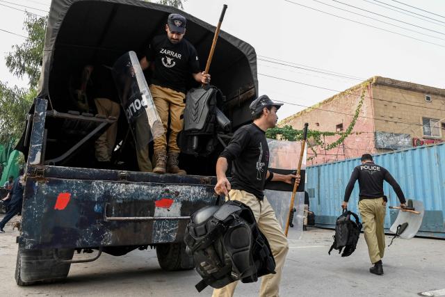 Police personnel arrive for their deployment amid ongoing protests by the opposition Pakistan Tehreek-e-Insaf (PTI) party demanding the release of jailed former prime minister Imran Khan in Peshawar on October 11, 2026. (Photo by Abdul MAJEED / AFP)