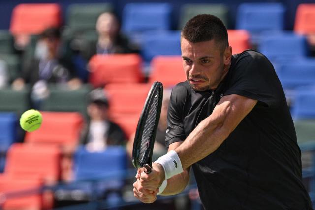 France's Arthur Gea hits a return to USA's Ben Shelton during their men's singles match at the Shanghai Masters tennis tournament in Shanghai on October 11, 2026. (Photo by Hector RETAMAL / AFP)