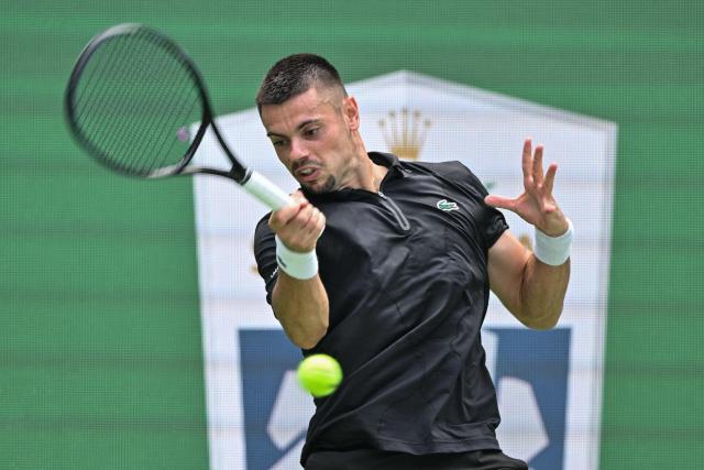 France's Arthur Gea hits a return to USA's Ben Shelton during their men's singles match at the Shanghai Masters tennis tournament in Shanghai on October 11, 2026. (Photo by Hector RETAMAL / AFP)