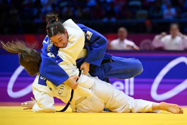 Uzbekistan's Shukurjon Aminova (white) competes against Germany's Mascha Ballhaus in the mixed team round of 16 at the World Judo Championships in Baku on October 11, 2026. (Photo by Alexander NEMENOV / AFP)