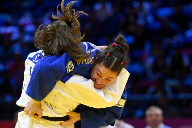 Uzbekistan's Shukurjon Aminova (white) competes against Germany's Mascha Ballhaus in the mixed team round of 16 at the World Judo Championships in Baku on October 11, 2026. (Photo by Alexander NEMENOV / AFP)